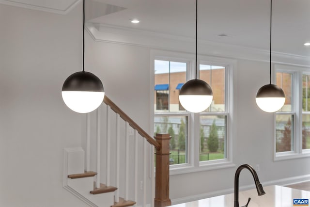 stairway featuring a healthy amount of sunlight and crown molding