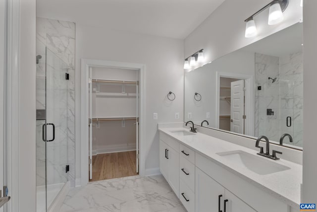 bathroom with vanity and a shower with shower door