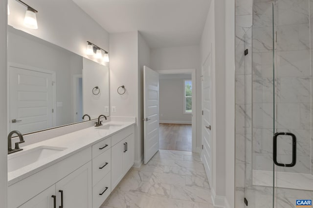 bathroom featuring vanity, wood-type flooring, and walk in shower