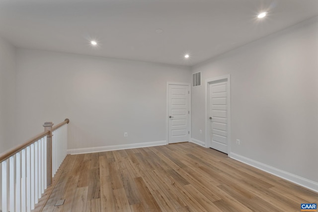 empty room with light hardwood / wood-style floors