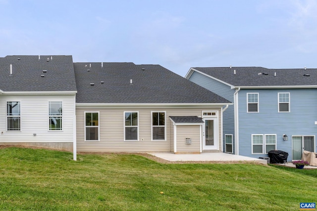 rear view of property with a yard and a patio