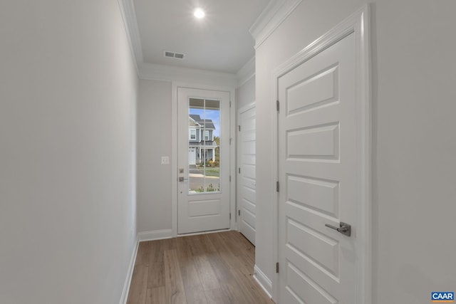 doorway to outside featuring light hardwood / wood-style floors and ornamental molding