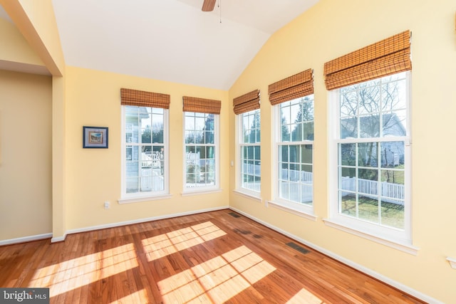 unfurnished sunroom featuring visible vents, a ceiling fan, and lofted ceiling