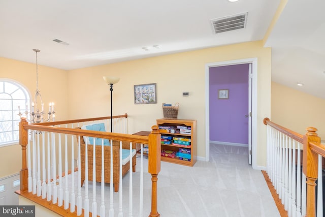 corridor with visible vents, an upstairs landing, light colored carpet, and a chandelier