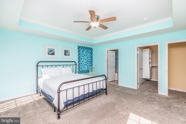 bedroom with a raised ceiling and baseboards