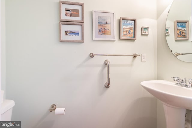 half bath featuring a sink and toilet