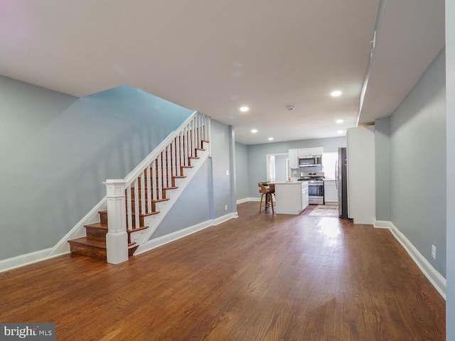 unfurnished living room with hardwood / wood-style flooring