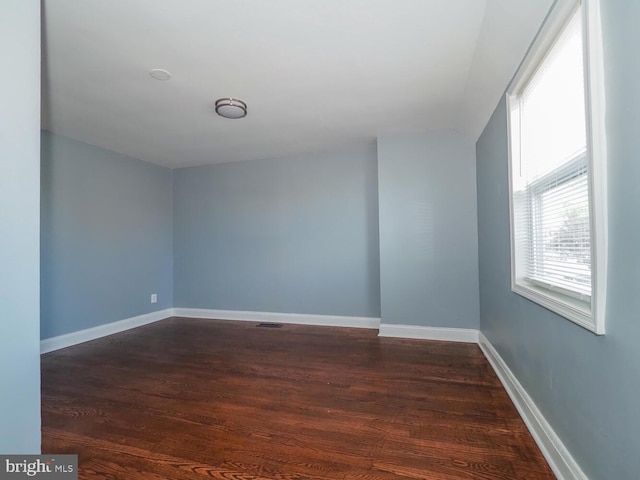 spare room with dark hardwood / wood-style floors