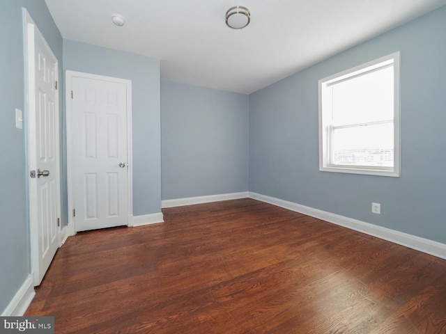 empty room featuring dark wood-type flooring