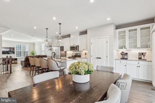 dining room featuring light wood-type flooring and sink