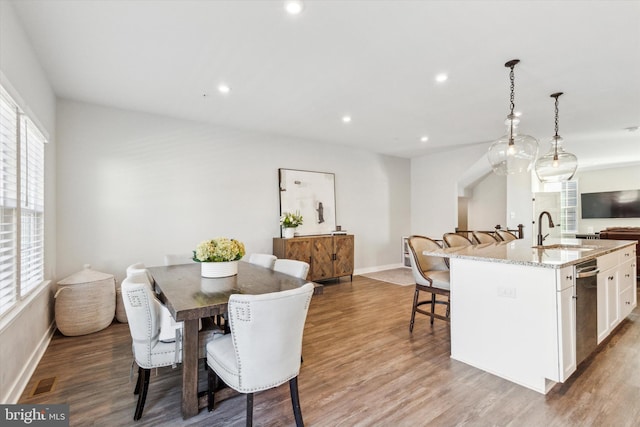 dining space featuring hardwood / wood-style floors and sink