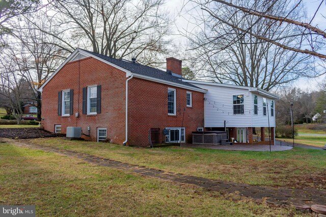 back of house with a lawn, a patio, and central AC unit