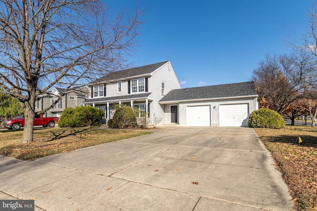 view of front of property with a front yard and a garage