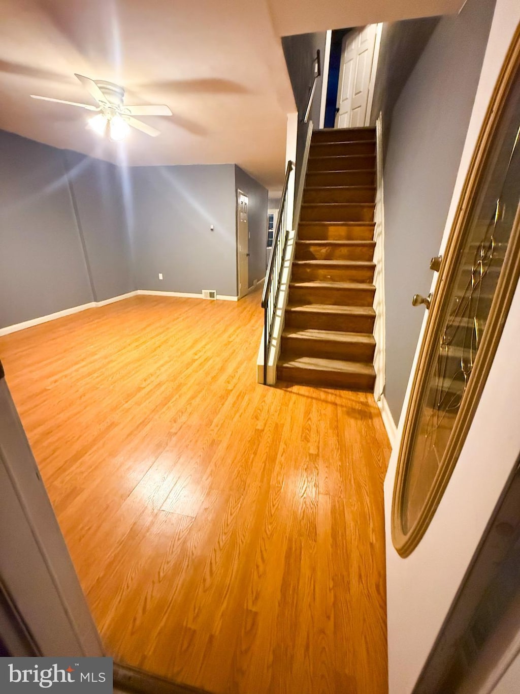 interior space with ceiling fan, baseboards, and wood finished floors