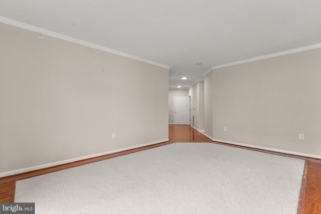 spare room featuring recessed lighting, crown molding, baseboards, and wood finished floors