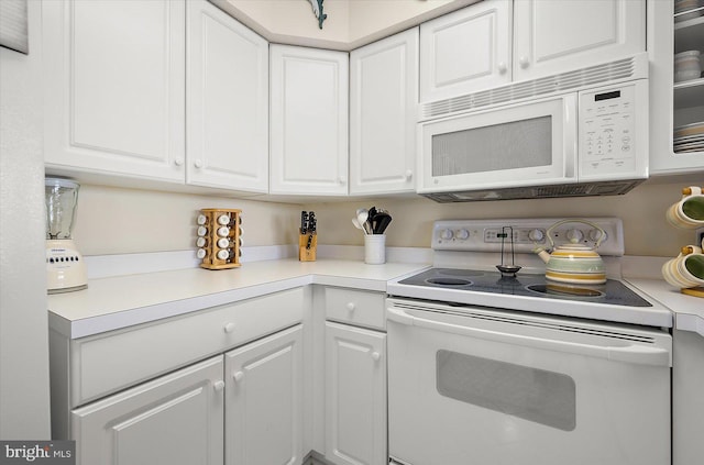 kitchen with white cabinets and white appliances