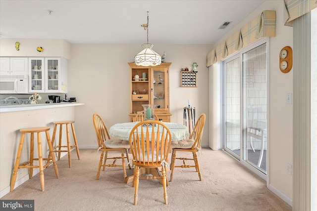 dining space with light carpet