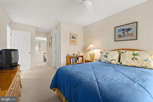 carpeted bedroom featuring ensuite bathroom and ceiling fan