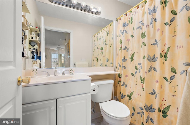 bathroom featuring tile patterned flooring, vanity, a shower with shower curtain, and toilet