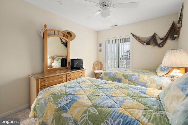 bedroom featuring carpet flooring, ceiling fan, and a textured ceiling