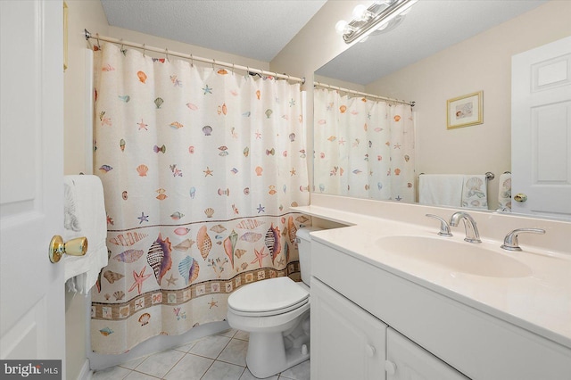 bathroom with tile patterned floors, vanity, a textured ceiling, and toilet