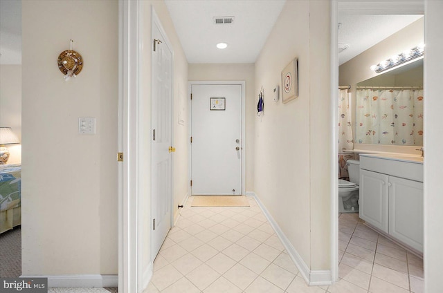 corridor featuring light tile patterned floors