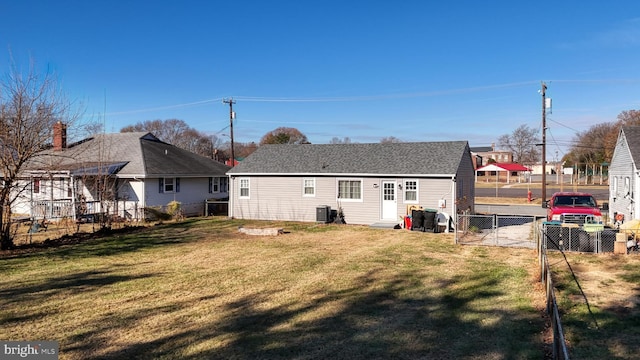 back of property with a lawn and cooling unit