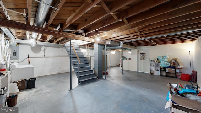 basement with washer and dryer and electric panel