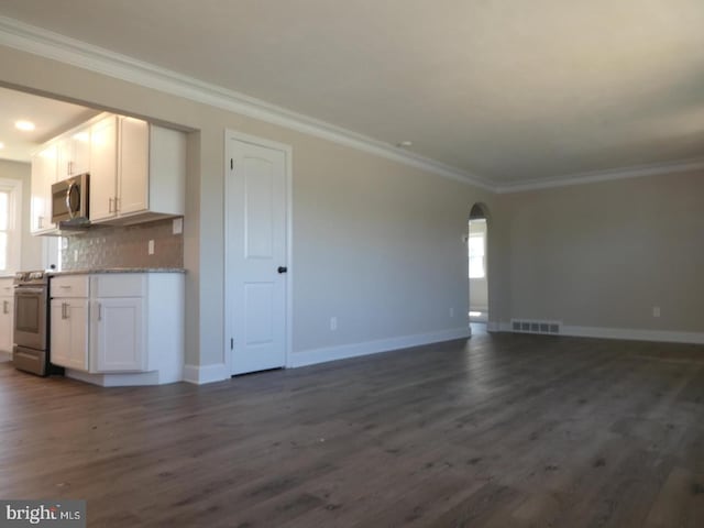 kitchen featuring white cabinets, stainless steel appliances, dark hardwood / wood-style floors, and crown molding