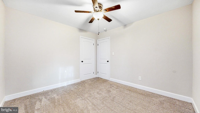 carpeted empty room featuring ceiling fan