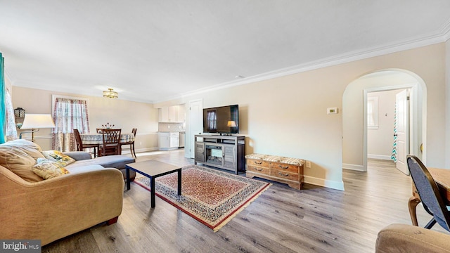 living room featuring wood-type flooring and ornamental molding