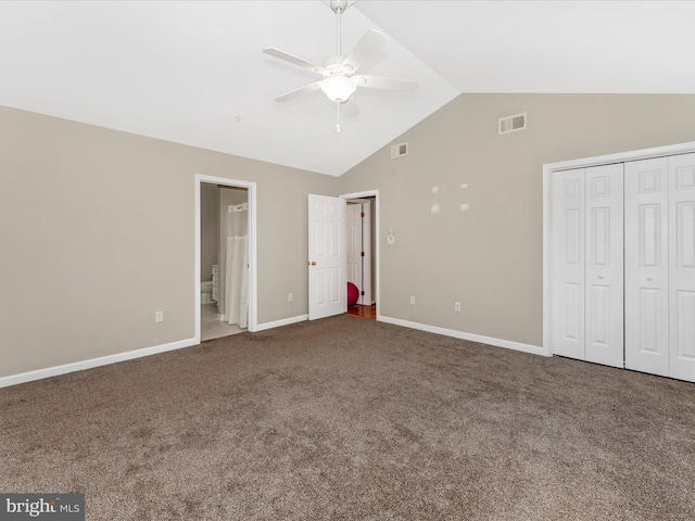 unfurnished bedroom featuring carpet flooring, ensuite bathroom, ceiling fan, and lofted ceiling