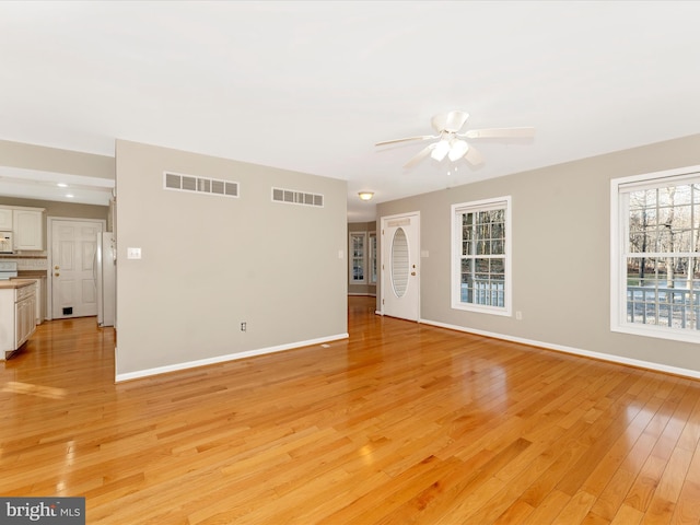 unfurnished living room featuring light hardwood / wood-style floors and ceiling fan