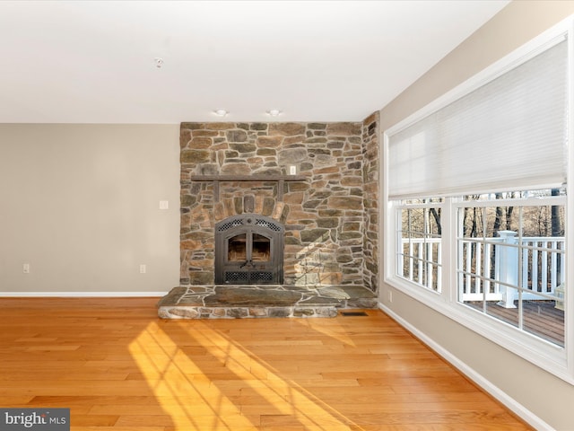 unfurnished living room with a fireplace and wood-type flooring