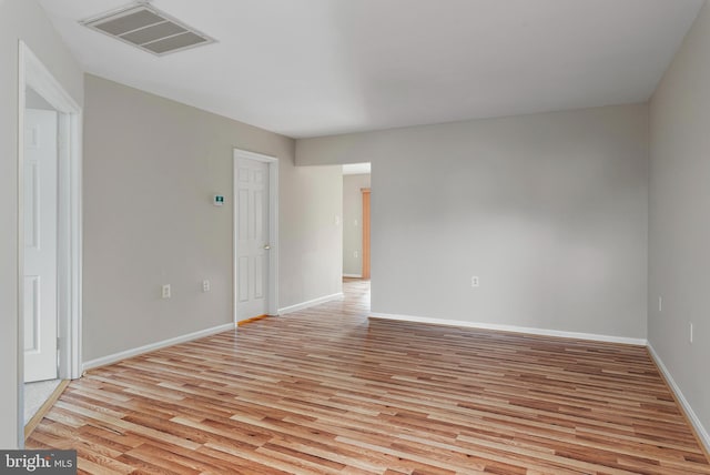 spare room with light hardwood / wood-style flooring