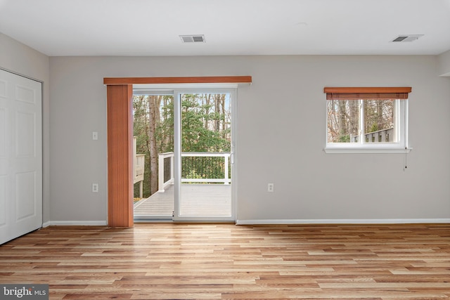 unfurnished room with light hardwood / wood-style floors