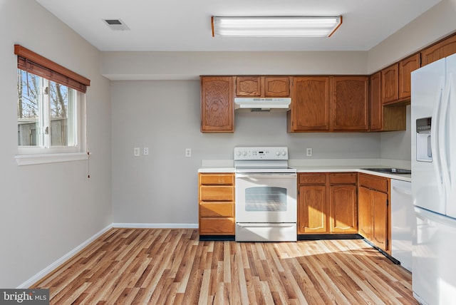 kitchen with light hardwood / wood-style floors and white appliances