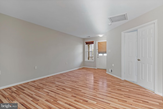 spare room with light hardwood / wood-style flooring