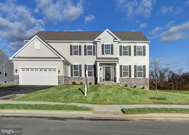 view of front facade with a front lawn and a garage