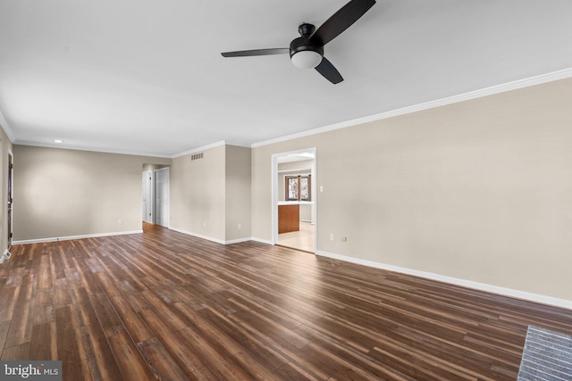 unfurnished room featuring dark hardwood / wood-style floors, ceiling fan, and crown molding