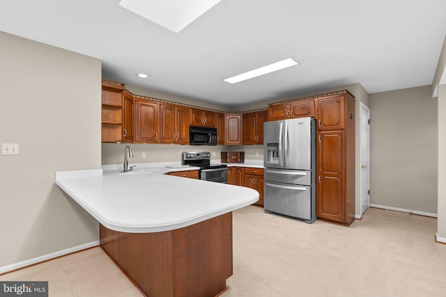 kitchen with black appliances, kitchen peninsula, and sink