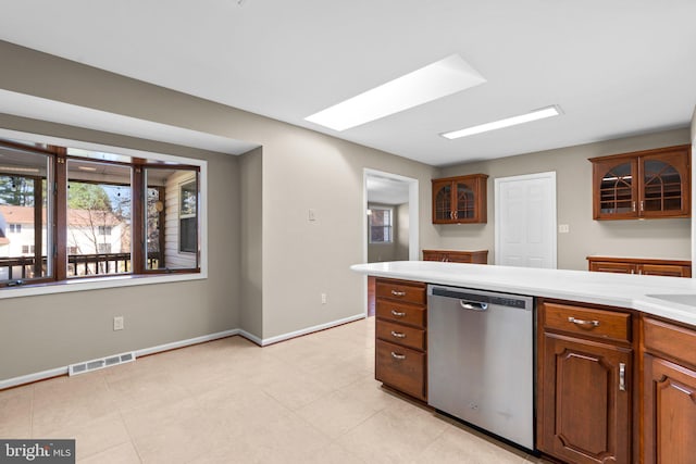 kitchen featuring a skylight and stainless steel dishwasher