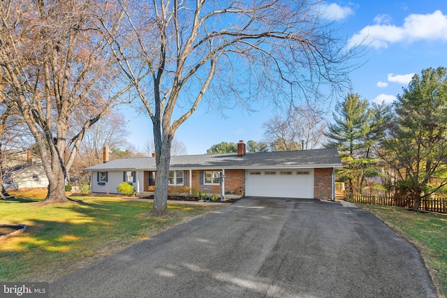 single story home featuring a front lawn and a garage