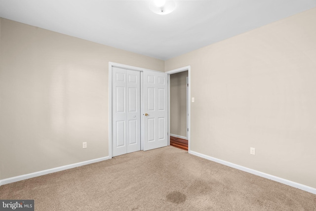 unfurnished bedroom featuring a closet and carpet floors