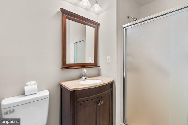 bathroom with vanity, toilet, and walk in shower