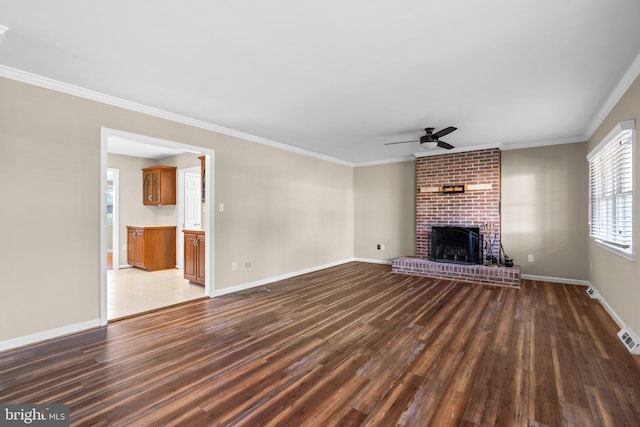 unfurnished living room with a fireplace, dark hardwood / wood-style flooring, ceiling fan, and ornamental molding