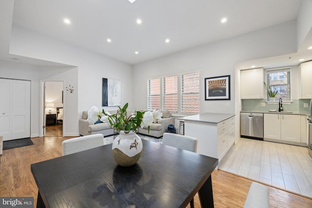 dining area with sink, plenty of natural light, and light wood-type flooring