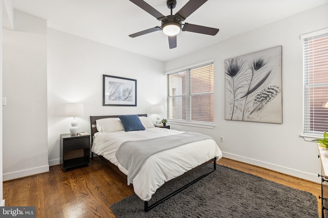 bedroom with ceiling fan and dark wood-type flooring