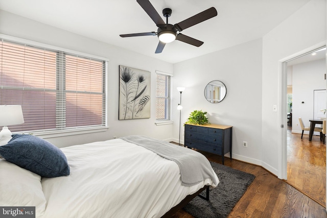 bedroom with dark hardwood / wood-style floors and ceiling fan