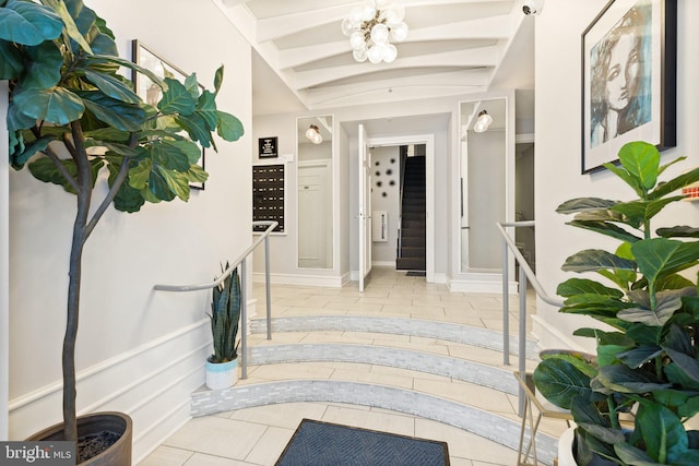 hallway with a chandelier and light tile patterned floors